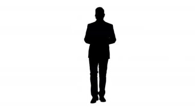Silhouette yakışıklı Müşteri Hizmetleri Merkezi operatörü bir kulaklık yürüyüş ve kamera konuşurken giyiyor.