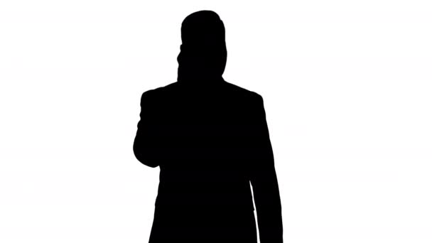 Silhouette Thoughtful young businessman in suit and tie making several calls quickly. — Stock Video