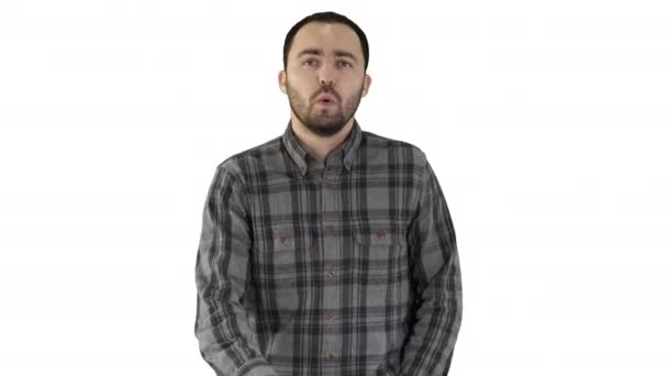 Young man walking and whistling on white background. — Stock Video