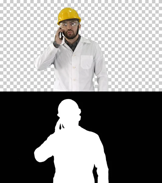 Engineer in protective glasses and hat walking, taking on the phone, Alpha Channel — Stock Photo, Image