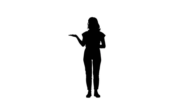 Silhouette Young beautiful woman amazed and smiling to the camera while presenting something with hand. — Stock Photo, Image