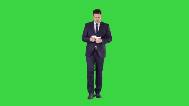 Человек в костюме ходит и считает деньги на зеленом экране, хрома ключ . — стоковое видео