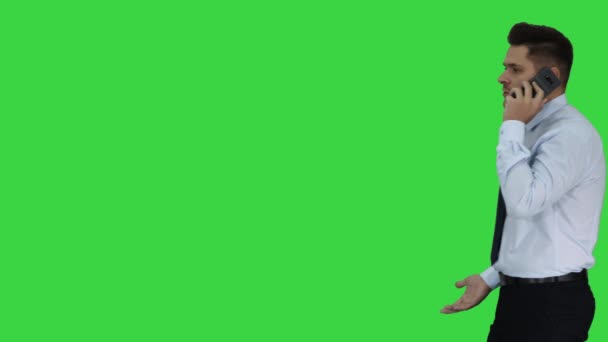 Angry businessman yelling at phone on a Green Screen, Chroma Key. — Stock Video