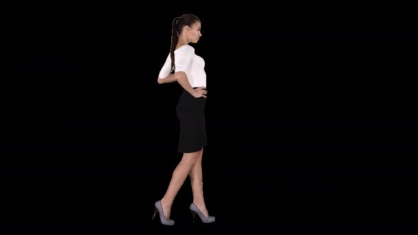 Beautiful young woman in elegant outfit walking, holding hands on hips, Alpha Channel — Stock Video