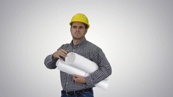 Engineer checking plan on construction site on gradient background. — Stock Video