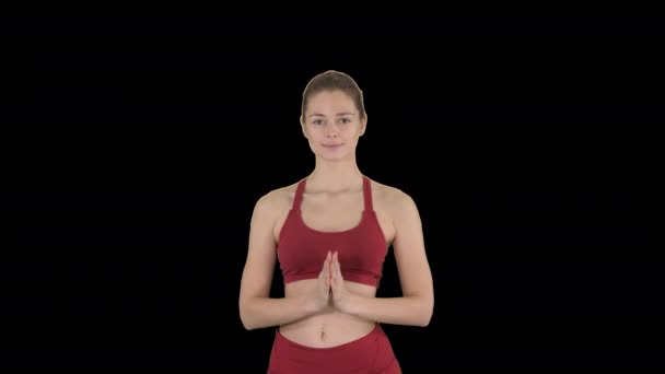 Fitness model preparing to do Utthita parsvakonasana pose, Alpha Channel — Stock Video