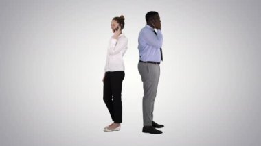 Genç Afro-Amerikan erkek ve kadın sırt sırta yapım telefon görüşmeleri degrade arka plan üzerinde duran.