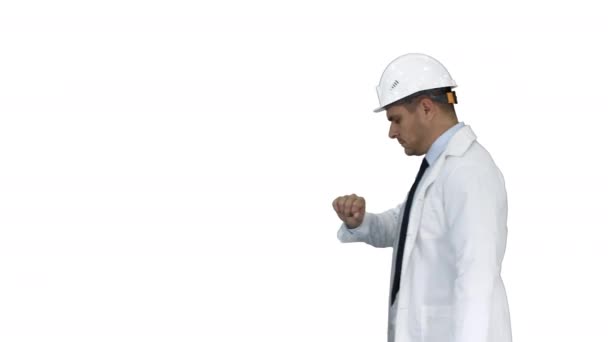 Retrato del arquitecto con sombrero de señora mirando el reloj como llegar tarde sobre fondo blanco. — Vídeos de Stock