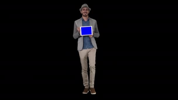 Casual man in a hat walking and showing digital tablet to camera, Alpha Channel — Stock Video