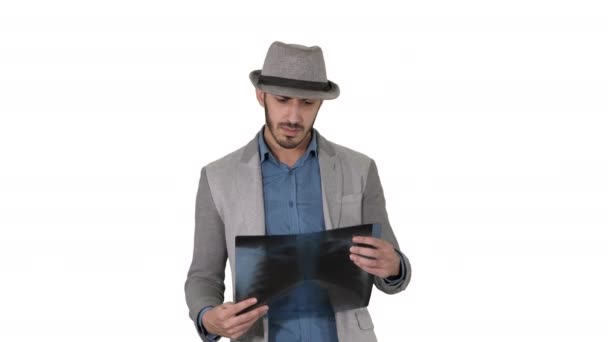 Casual man looking at x-ray of lungs and walking on white background. — Stock Video