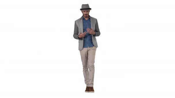 Trendy uomo allegro positivo elegante indossa camicia casual e cappello da sole a piedi e parlando con la fotocamera su sfondo bianco. — Video Stock