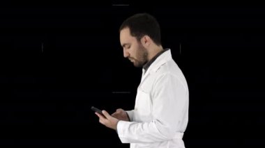 Yakışıklı erkek sağlık hizmetleri uzmanının, doktorun ya da hemşirenin yakın plan portresi, cep telefonundan mesaj, Alpha Channel