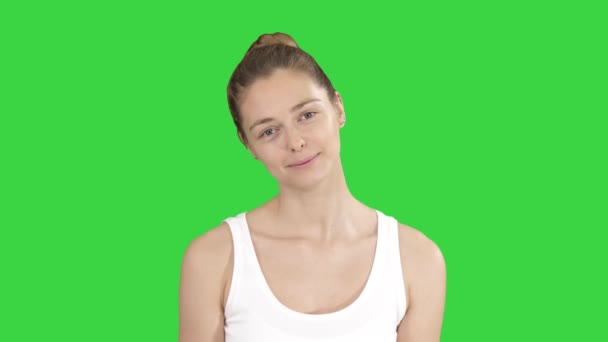 Smiling Woman Relaxing Her Neck Muscles Doing Stretching Exercise on a Green Screen, Chroma Key. — Stock Video