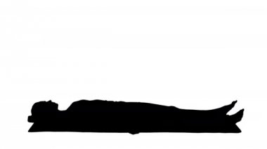 Siluet Yoga meditasyonu kapalı gözlerle bir paspasın üzerinde yatıyor..