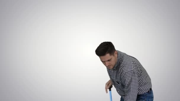 Floor care and cleaning services Casual man cleaning the floor and showing thumb up gesture on gradient background. — Stock Video