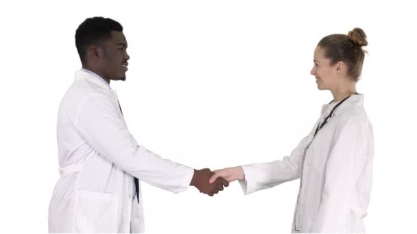 Doctors shaking hands and posing to camera on white background. — Stock Video