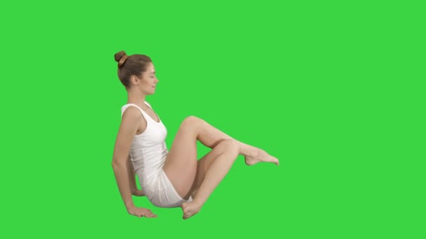 Young beautiful woman doing yoga asana Marichyasana on a Green Screen, Chroma Key. — Stok video