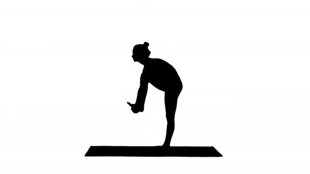 Silhouette Beautiful young fit woman in sportswear doing sport exercise, bending in variation of Utthita Hasta Padangusthasana, Dandayamana-Janushirasana, Standing Head to Knee Bikram posture. — Stock Video