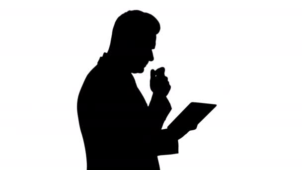 Silhouette Smart senior businessman using a technology tablet. — Stock Video