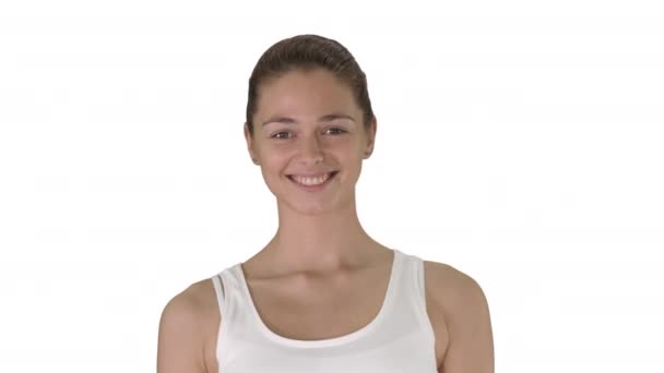 Gyönyörű fiatal nő nyújtózkodik magát reggel a fehér háttér. — Stock videók