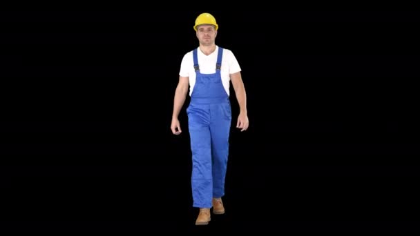 Walking worker in yellow helmet, Alpha Channel — Stock Video