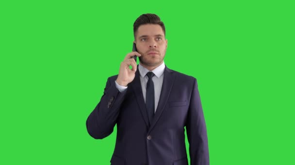 Businessman listening closely to caller on a Green Screen, Chroma Key. — Stock Video