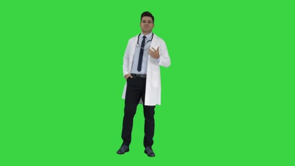 Friendly and playful male doctor and confident talking to camera on a Green Screen, Chroma Key. — Stock Video