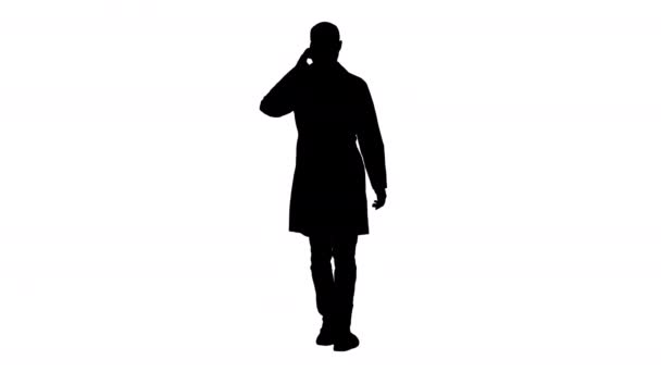 Silhouette Professional medical doctor talking on mobile phone while walking. — Stock Video