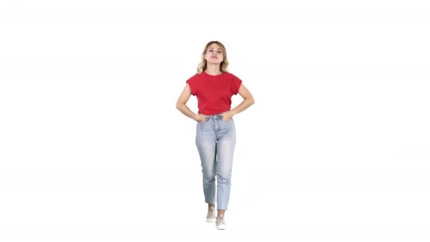 Blond woman walking with hands in her pockets and talking to camera on white background. — Stock Video