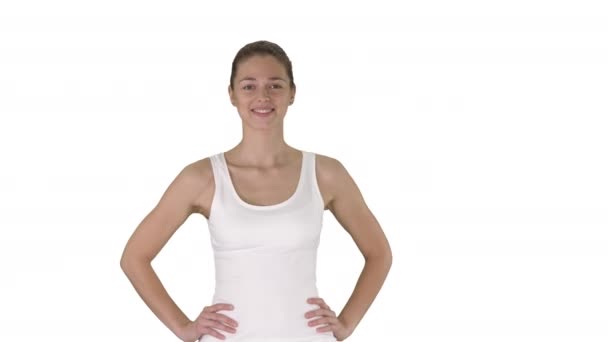 Nöjd säker aktiv frisk kvinna i sportkläder med händerna på höfter gå på vit bakgrund. — Stockvideo