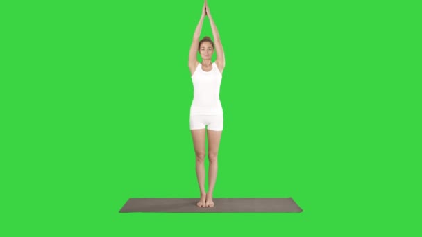 Attractive girl standing in the balancing yoga pose Garudasana Young woman in the Eagle yoga pose on a Green Screen, Chroma Key. — Stock Video