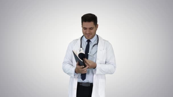 Doctor reading Medical Report of Patient or Recepie or Text book on gradient background. — Stock Video