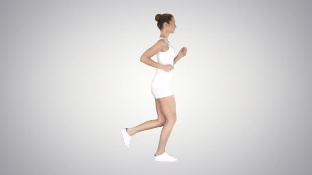 Athletic woman running on gradient background. — Stock Video