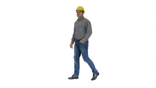 Smiling construction worker in yellow helmet looking at perfect well built object Hands on hips on white background. — Stock Video