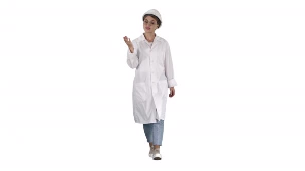 Young female engineer or architect making presenting gestures and talks on white background. — Stock Video