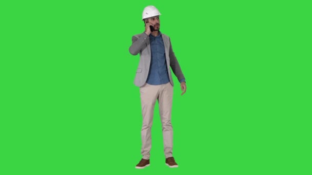 Engineer talking a mobile phone inspecting construction work of crane on a Green Screen, Chroma Key. — Stock Video