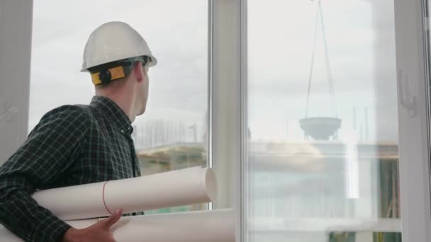 Engineer or architect holding blueprint and looking at the camera. — Stock Video
