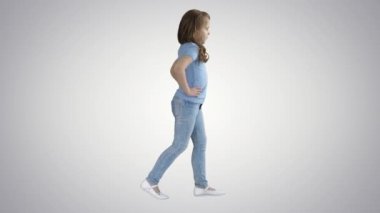 Rahat kıyafetler degrade arka planda yürüyüş küçük kız.