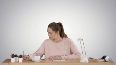 Mutlu öğrenci okuyan ve degrade arka planda bir dijital tabletten notlar alarak öğrenme.