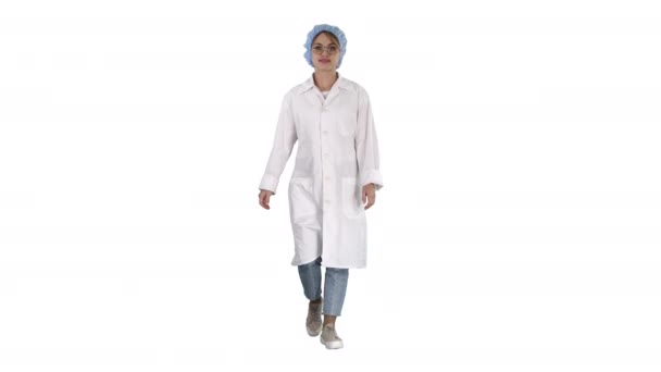 Pediatria sorridente che si tiene per mano in tasche di uniforme e cammina su sfondo bianco . — Video Stock