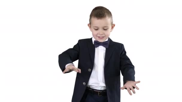 Boy in a formal suit kicking football on white background. — Stock Video