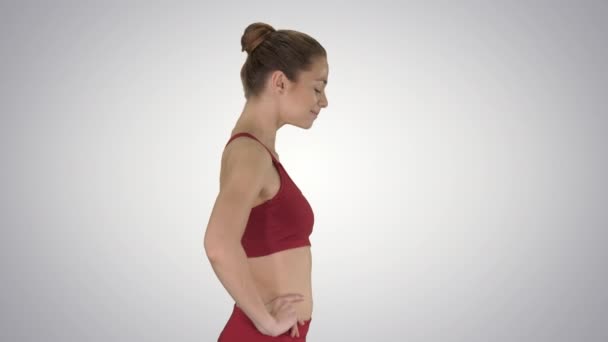 Жінка ходить і робить вправи для розтягування шиї, щоб звільнити нарощування напруги на градієнтному фоні . — стокове відео