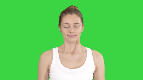 Молодая женщина делает дыхательные упражнения на зеленом экране, Chroma Key . — стоковое видео