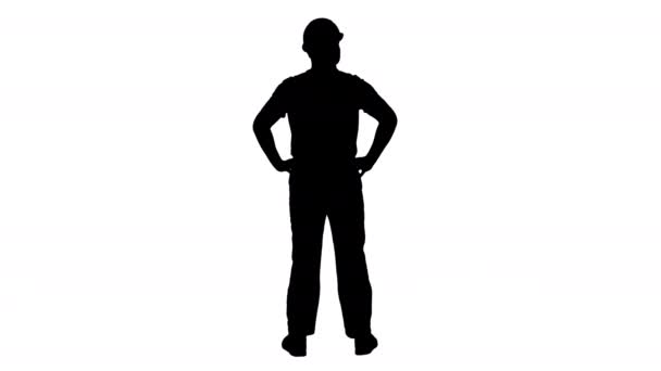 Silhouetten-Ingenieur im Bauhelm steht mit den Händen auf den Hüften und schaut sich um. — Stockvideo