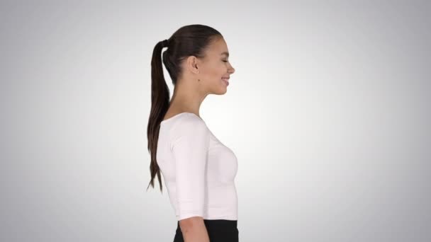 美しくエレガントなヒスパニック系のビジネス女性が歩くとグラデーションの背景に笑みを浮かべて. — ストック動画