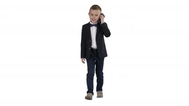 Little boy in a costume making a phone call while walking on white background. — Stock Video