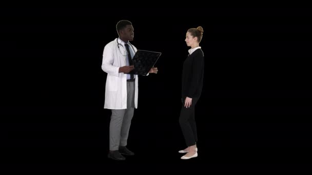 Врач показывает пациенту результаты рентгена, затем пациент уходит, Альфа-канал — стоковое видео
