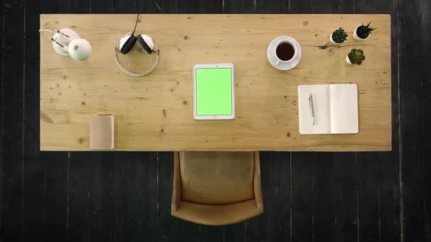 Flat lay of office desk with tablet in the middle. Green Screen Mock-up Display. — Stock Video