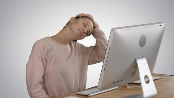 Exhausted young female sit at home office desk massaging neck on gradient background. — Stock Video