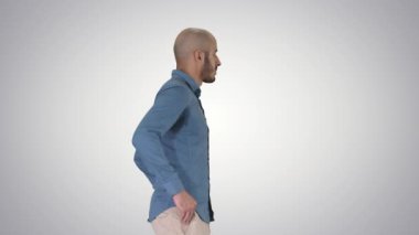 Model modelinden emin, elleri cebinde gradyan arka planda yürüyor..